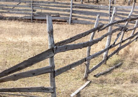 Old wooden fence on the nature in early spring.