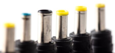 Plugs for charging a laptop on a white background. Macro