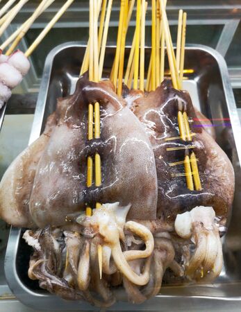 Squid meat on skewers for frying on the grill. Exotic foodの写真素材