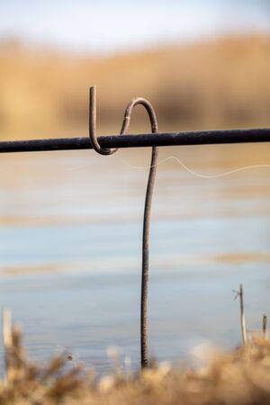 Stand for fishing rods on the shore of the pond. Inventory of the fisherman
