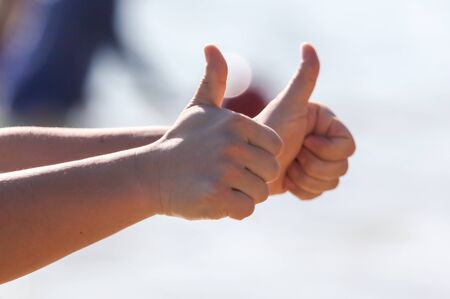 A man shows a thumbs up with his hands. Signの写真素材