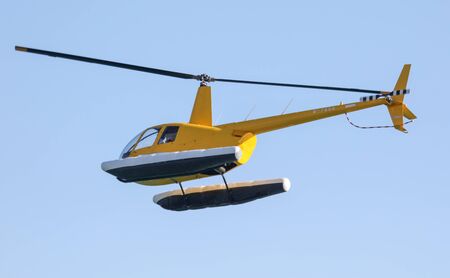 Helicopter flies in the blue sky. Aviationの写真素材