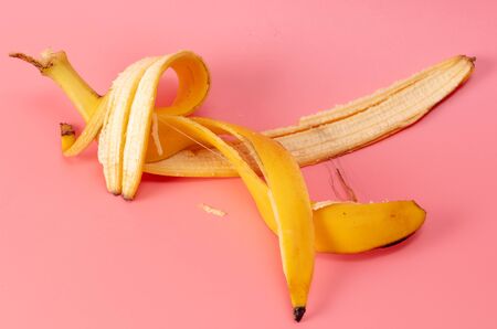 Banana peel isolated on a pink background. Tropical fruit.の写真素材