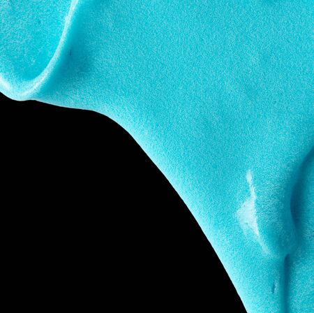 Blue slime isolated on black background. Jelly-like material for children to playの写真素材