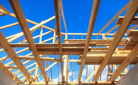 Wooden boards on the roof of the house against the sky. Home construction