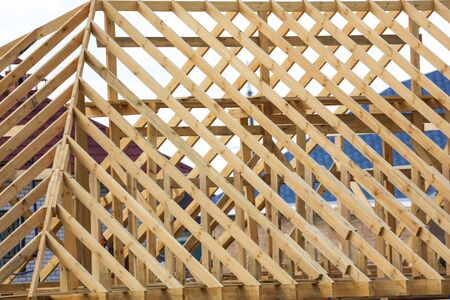 Wooden boards on the roof of the house against the sky. Home constructionの写真素材