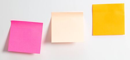 Colored papers hang on a white background. For your text