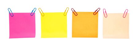 Colored pieces of paper with paper clips on a white background. For your text