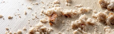 Bread crumbs on a wooden table. Leftover foodの写真素材