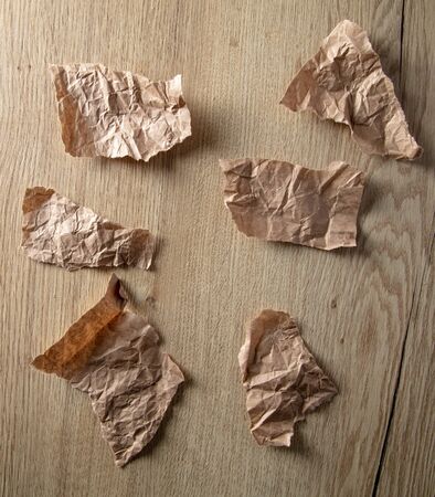 Crumpled paper on a wooden background.の写真素材