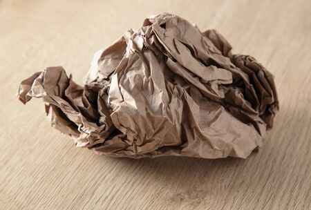 Crumpled paper on a wooden background.の写真素材