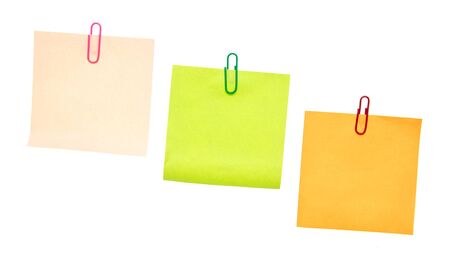 Colored pieces of paper with paper clips on a white background. For your text