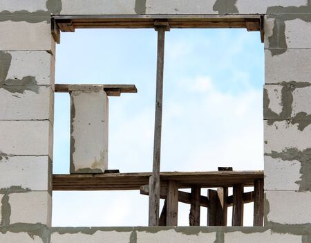 Window in the brick walls. Home construction