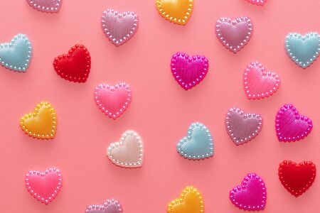 Multi-colored hearts on a pink background. Love card