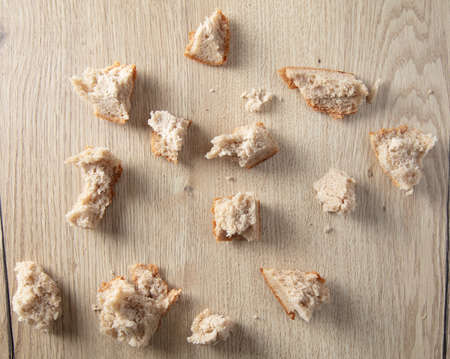 Bread crumbs on a wooden table. Leftover foodの写真素材
