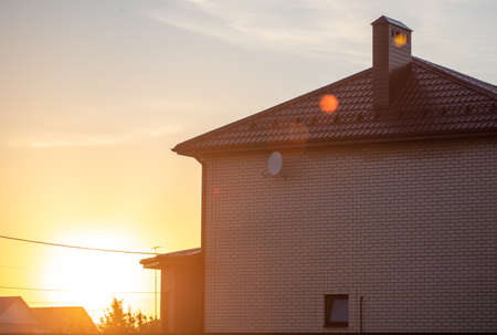 House in a village in the sunset.の写真素材