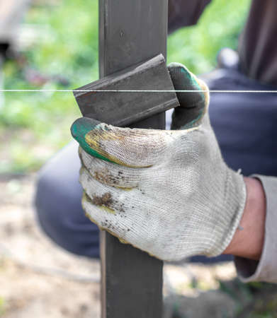 Installation of metal in the soil for the gate on the fence.の写真素材