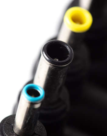 Plugs for charging a laptop on a white background. Macroの写真素材