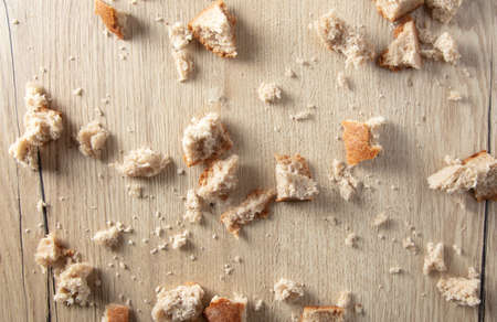 Bread crumbs on a wooden table. Leftover foodの写真素材