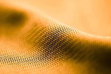 Golden fabric as an abstract background. Texture