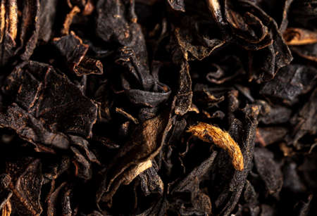 Close up of granules of black tea as a background. Macro
