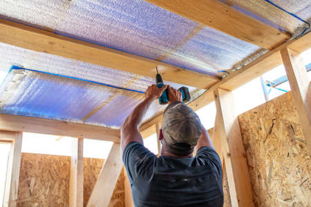 Work insulates the ceiling in the room. Building a house.の写真素材