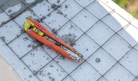 The tool is at the construction site of the house. Technology