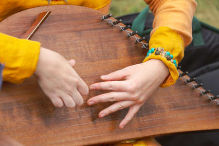 Girl musician plays the harp.の写真素材