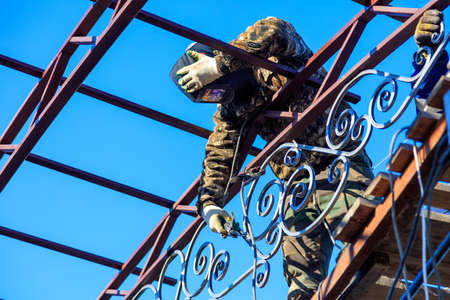 A worker welds metal onto the canopy frame. Technologyの写真素材