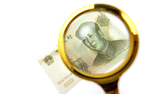 Chinese yuan in the collection. View through a magnifying glassの写真素材