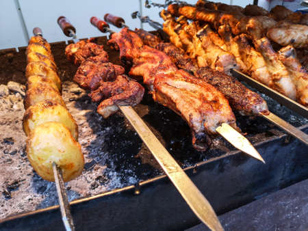 Shish kebab on skewers is fried on coals on the grill.の写真素材