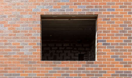 A window in a brick house under construction.の写真素材