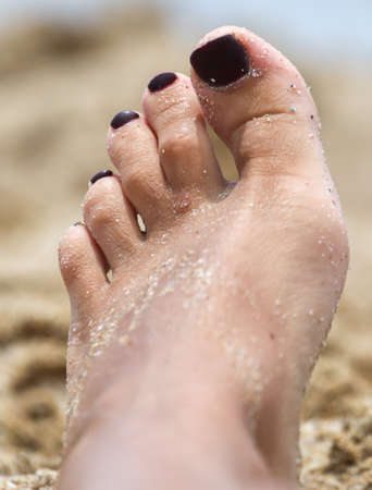 Girl's feet in the sand by the sea. Recreationの写真素材