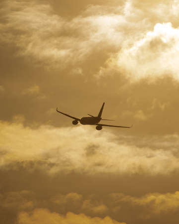Silhouette of an airplane at sunset. Air Transport