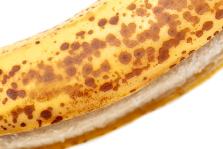 Dots on the skin of a banana. Fruit on a white backgroundの写真素材