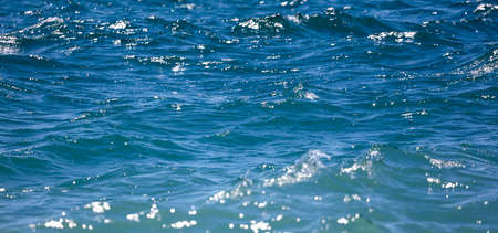 Blue surface of water in the sea as an abstract background. Texture