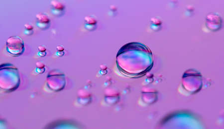 Blue drops of water on a pink background. Close-upの写真素材