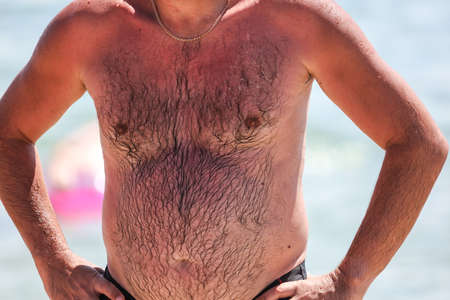 Body hair of a man on the beach.の写真素材