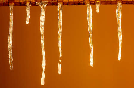 Icicles in winter in the rays of the dawn of the sun. Close-upの写真素材