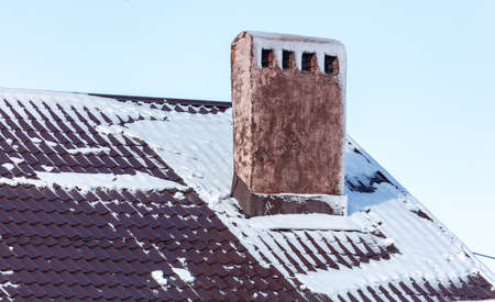 Snow on the roof of the house. Nature in winterの写真素材