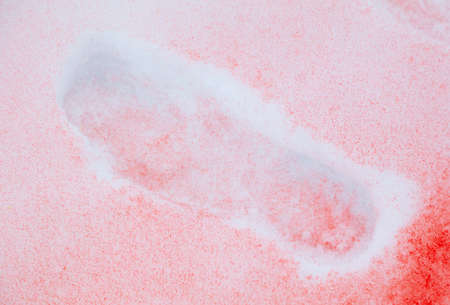 Trail with red paint on the snow in winter. Abstract background.の写真素材