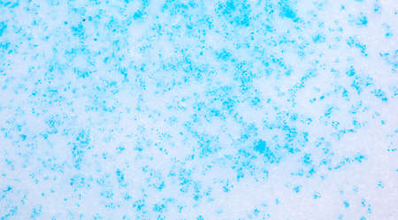 Blue paint on the snow in winter. Abstract background.