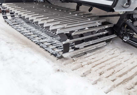 Car with caterpillars on a snowy road in winter.の写真素材