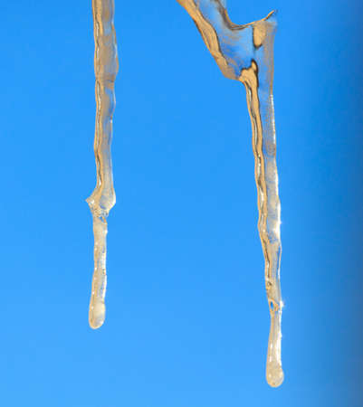 Icicles in winter against a blue sky. Close-upの写真素材