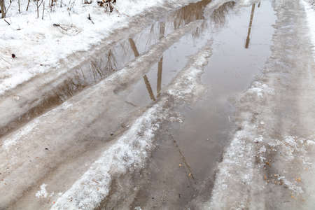 The road with melting snow in nature. Background.