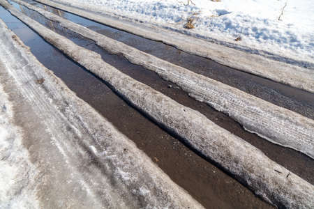 The road with melting snow in nature. Background.の写真素材