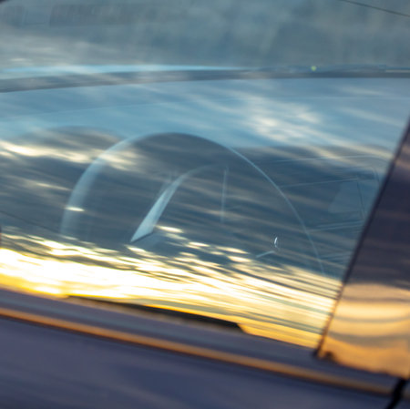 Reflection of the sky on the glass of a car at sunset.の写真素材
