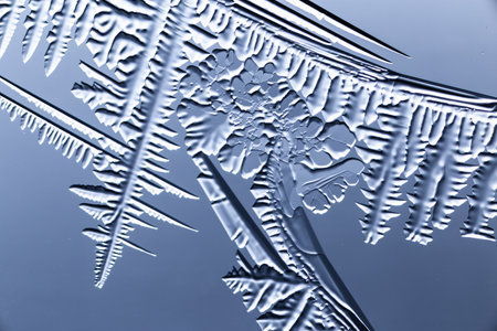 Blue patterns from frost on glass as a background. Close-upの写真素材