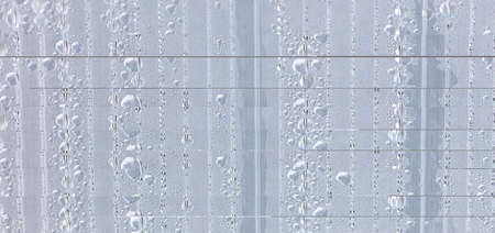 Water drops on glass as an abstract background. Close-up