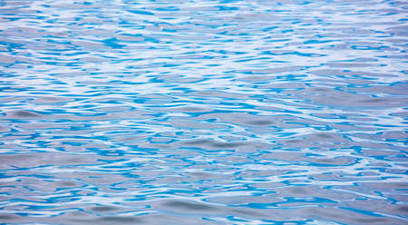 The smooth surface of the sea as an abstract background.
